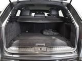 a trunk of a car with luggage in the back