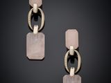 a pair of earrings with pink stone and silver metal