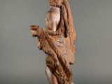 an image of a statue of a man holding a bird on a wooden base