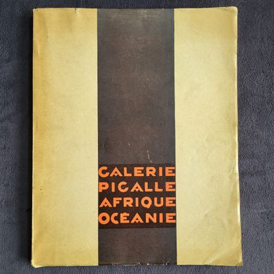 an old book sitting on top of a table covered in yellow and black stripes