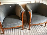 two chairs sitting next to each other on a rug