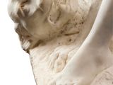 a statue of a woman laying down on a pillow