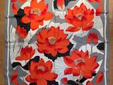 a close up of a square scarf with red flowers on it