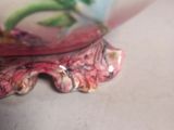 a close up picture of a bowl with a flower on it