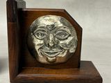a bookend with a face on it on a table