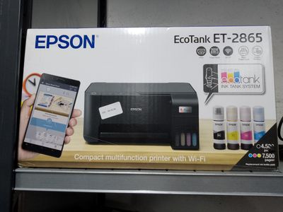 a box with a printer and a cell phone in it