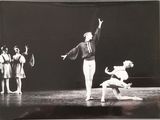 a black and white photo of a man and a woman on a stage