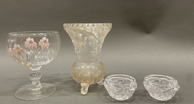 three glasses and a vase sitting on a table