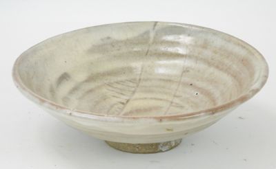 a white and brown bowl on a white surface