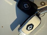 a picture of a car key and a remote on the hood of a car