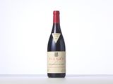 a bottle of red wine sitting on top of a table
