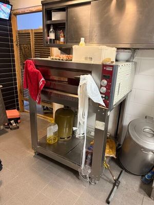an image of a commercial kitchen with a stove and oven