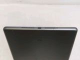 the back of a laptop computer sitting on top of a white table