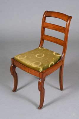 a wooden chair with a green cushion on it