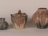 three vases that are sitting next to each other on a table