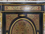 a black and gold cabinet with a clock on top of it