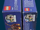 two boxes of legos that are sitting on a table