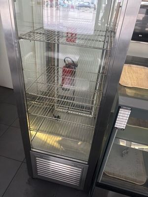 a glass display case with a fire extinguisor inside of it