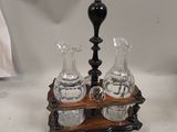 two glass vases sitting on a wooden stand