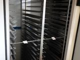 an image of a metal rack with trays of food