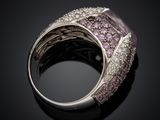 a close up of a ring with pink and white diamonds
