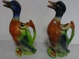 two vases that have birds on them on a table