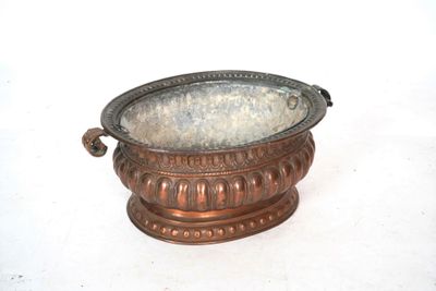 a metal bowl that is sitting on a white surface