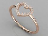 a rose gold ring with a heart shaped diamond set in the center