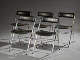 three black leather folding chairs sitting on top of a white floor