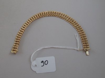 a gold chain bracelet with a price tag attached to it