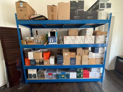 a blue shelving with many boxes on top of it