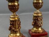 pair of antique brass candlesticks on red marble bases