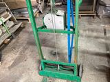 a green hand truck that is sitting in the garage