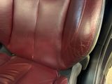 a close up of a red leather seat in the back of a car