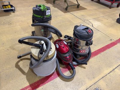 several vacuums are lined up on the floor in a warehouse