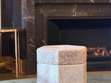 a small stool sitting in front of a fireplace in a living room