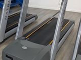 two tread machines that are on the floor in the room