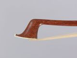 a close up of a violin bow with a wooden handle