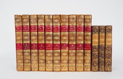 several old books are lined up in a row on a white surface
