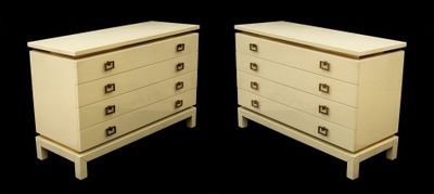 pair of white dressers with drawers against a black background