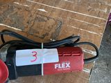 a red and black polisher sitting on a wooden table