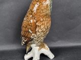a figurine of an owl sitting on a branch
