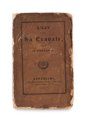 an old book sitting on top of a white surface