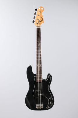 a black electric bass guitar hanging from a white wall