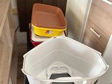 two bins sitting on top of a table in a room