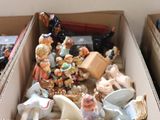 two boxes with figurines in them sitting on a table