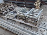 many pieces of metal on a pallet in a warehouse