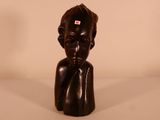 sculpture of a woman ' s head with a red tag on it ' s forehead