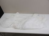 a white table with a white dress on top of it