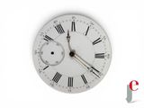 a white clock with roman numerals on the face